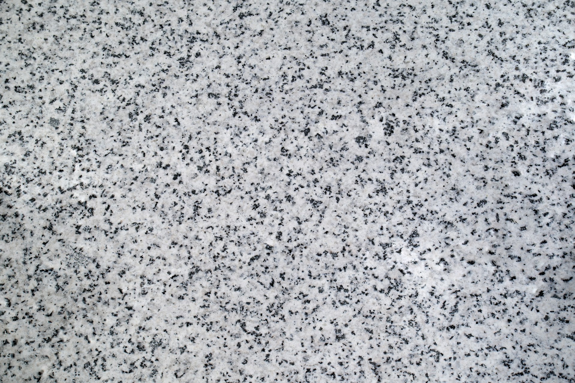 A black and white photo of a granite counter top